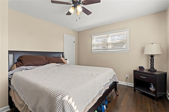 bedroom with a ceiling fan, baseboards, and wood finished floors