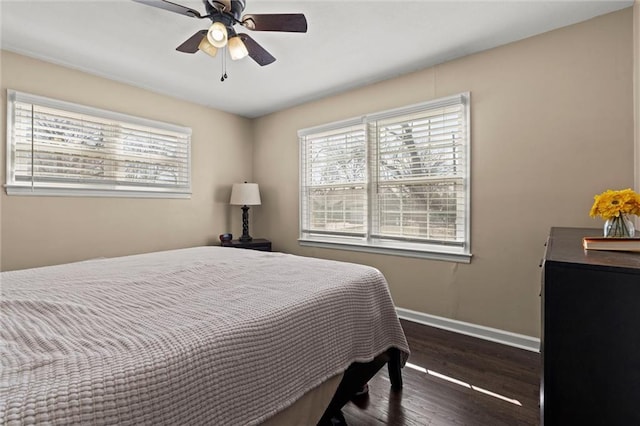 bedroom with a ceiling fan, baseboards, and wood finished floors