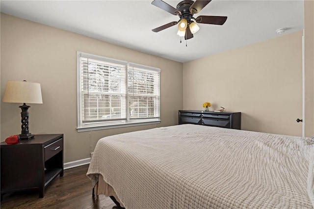 bedroom with a ceiling fan, dark wood-style flooring, and baseboards