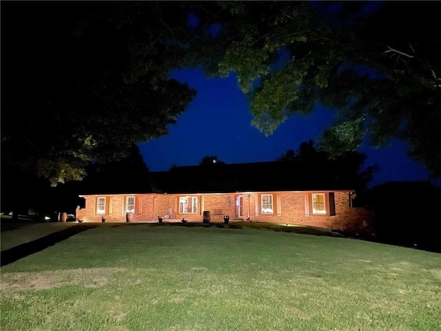 ranch-style home featuring a yard