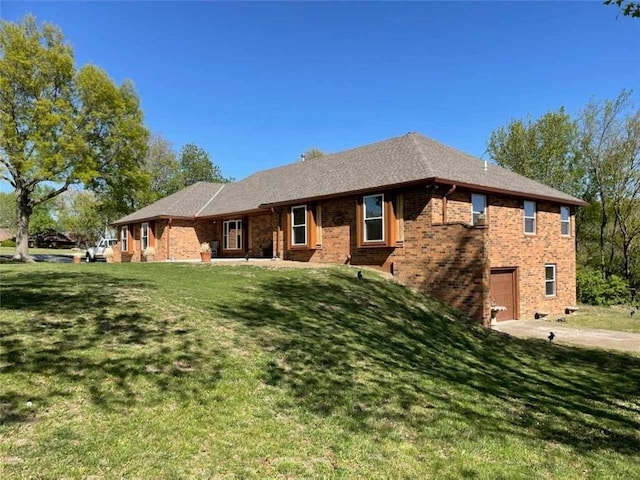 view of front of house with a front yard and a garage