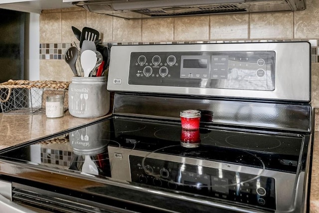 details with stainless steel range with electric cooktop and decorative backsplash