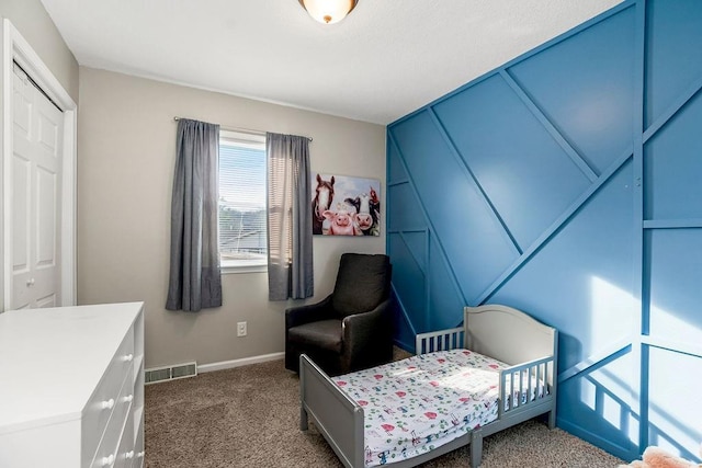 carpeted bedroom featuring visible vents and baseboards