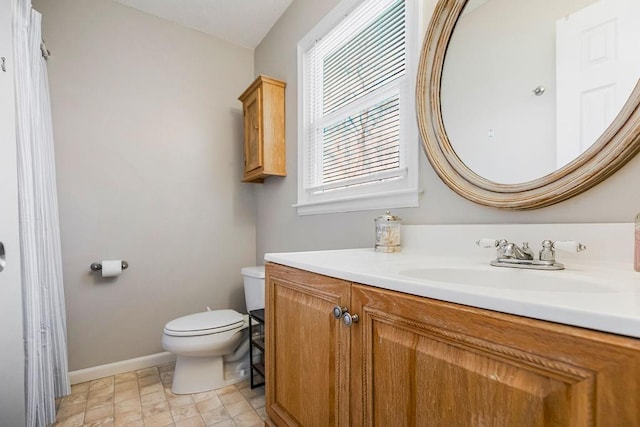 full bathroom with vanity, toilet, and baseboards