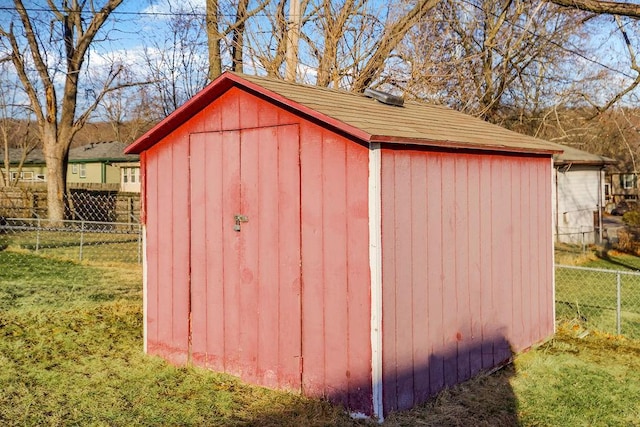 view of shed featuring fence