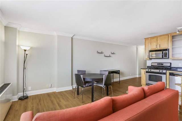 living area featuring baseboards, ornamental molding, and dark wood finished floors