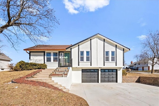 view of front of home with driveway, an attached garage, and stairway