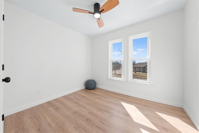 unfurnished room with ceiling fan, baseboards, and wood finished floors