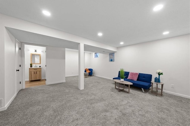 living area featuring carpet floors, visible vents, baseboards, and recessed lighting