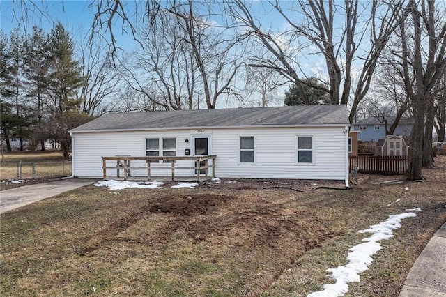 ranch-style house with an outbuilding, a deck, and a storage unit