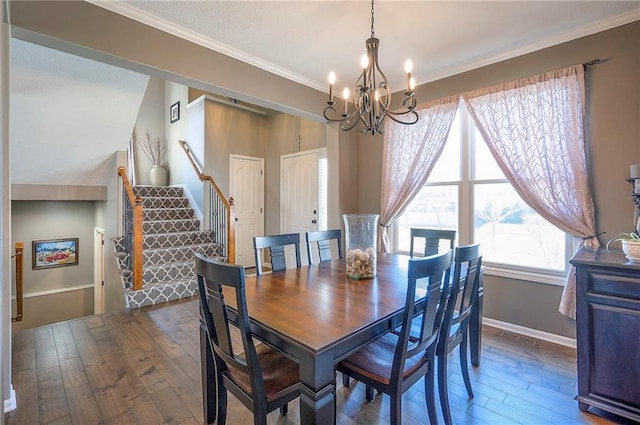 dining space with crown molding, baseboards, stairway, hardwood / wood-style flooring, and a notable chandelier