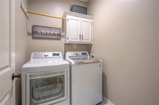 washroom with cabinet space and washing machine and dryer