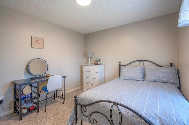 carpeted bedroom featuring a textured ceiling and baseboards