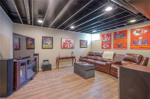 living room featuring light wood-style flooring and baseboards