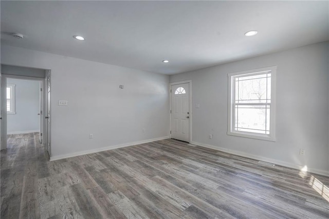 entryway featuring recessed lighting, plenty of natural light, baseboards, and wood finished floors