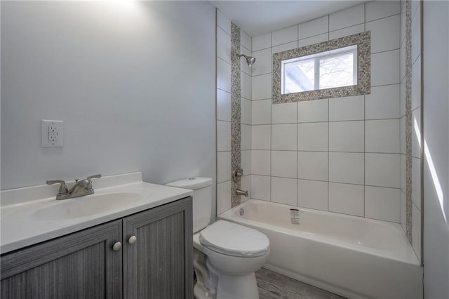 bathroom featuring shower / bathtub combination, toilet, and vanity