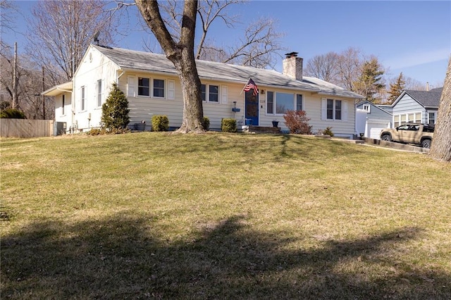 back of property featuring a yard, fence, central AC, and a chimney