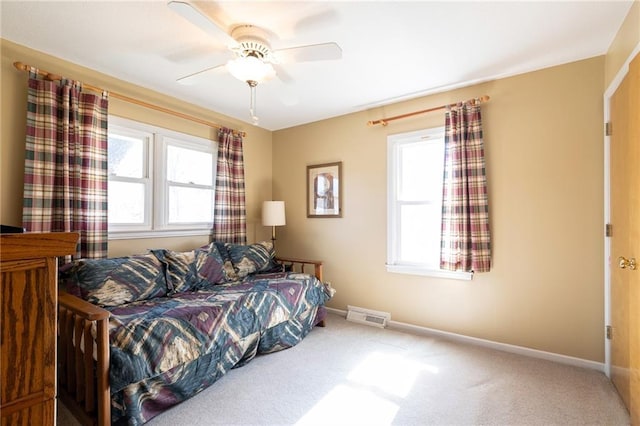 bedroom with visible vents, carpet floors, baseboards, and ceiling fan