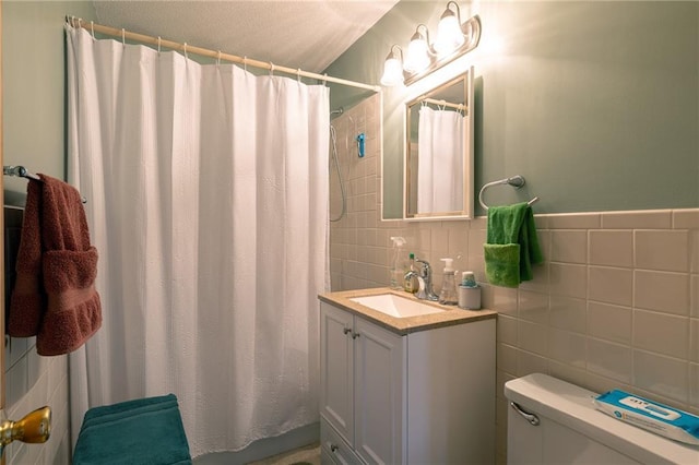 bathroom featuring a shower with shower curtain, toilet, tile walls, and vanity