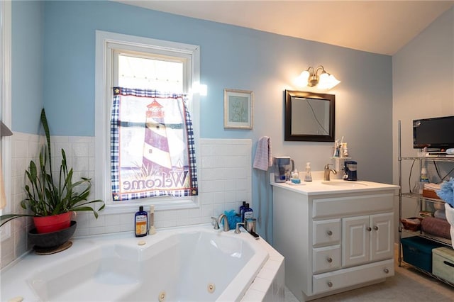 full bathroom with a tub with jets and vanity