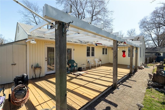 rear view of house with a deck and a pergola