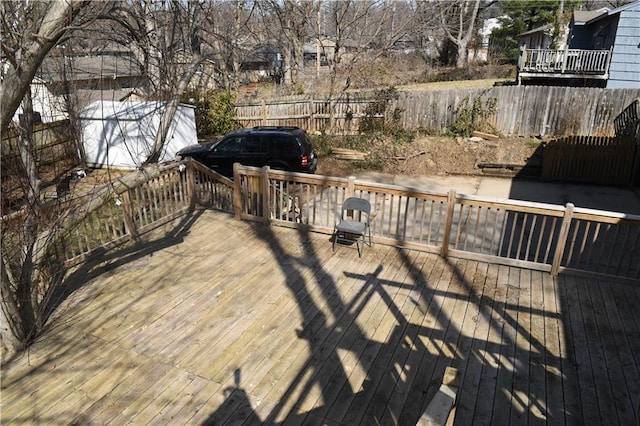 wooden terrace featuring fence