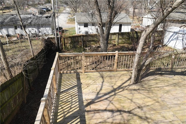 view of patio featuring a wooden deck, a residential view, and a fenced backyard