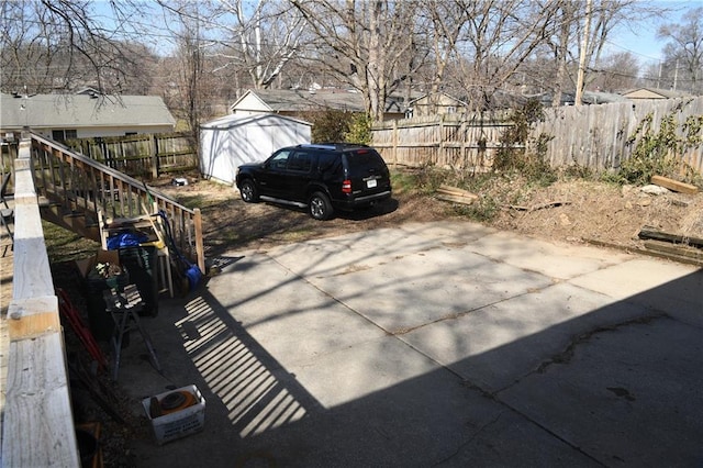 exterior space with a storage shed and fence