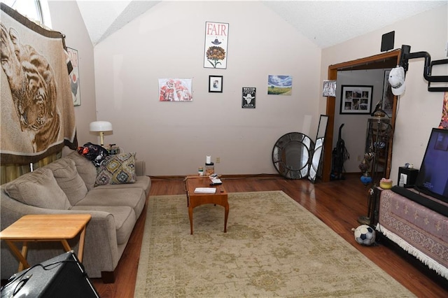 living room featuring lofted ceiling and wood finished floors