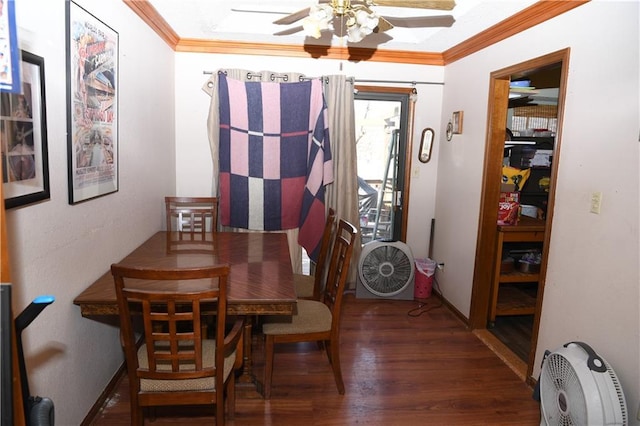 dining space featuring ceiling fan, baseboards, wood finished floors, and crown molding