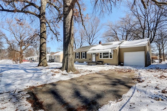 view of front of home featuring a garage and a chimney