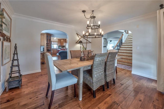 dining area with arched walkways, dark wood-style flooring, and crown molding