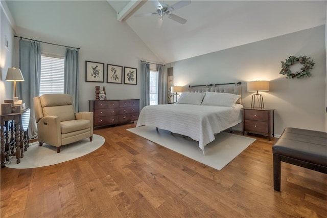 bedroom featuring ceiling fan, high vaulted ceiling, wood finished floors, and beamed ceiling