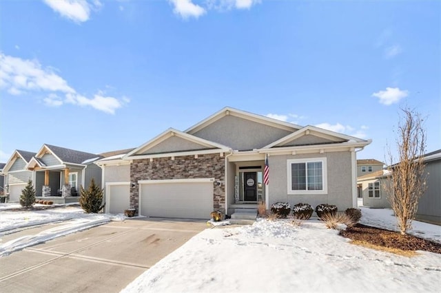 view of front of home featuring a garage, driveway, stone siding, and stucco siding