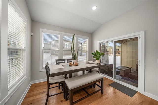 dining area featuring lofted ceiling, recessed lighting, wood finished floors, and baseboards