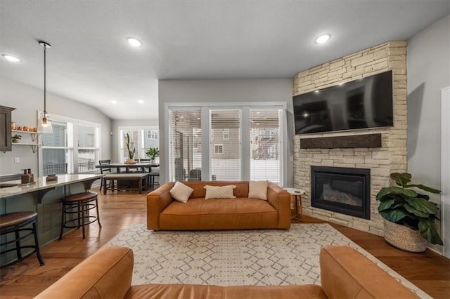 living room featuring a fireplace, wood finished floors, and recessed lighting