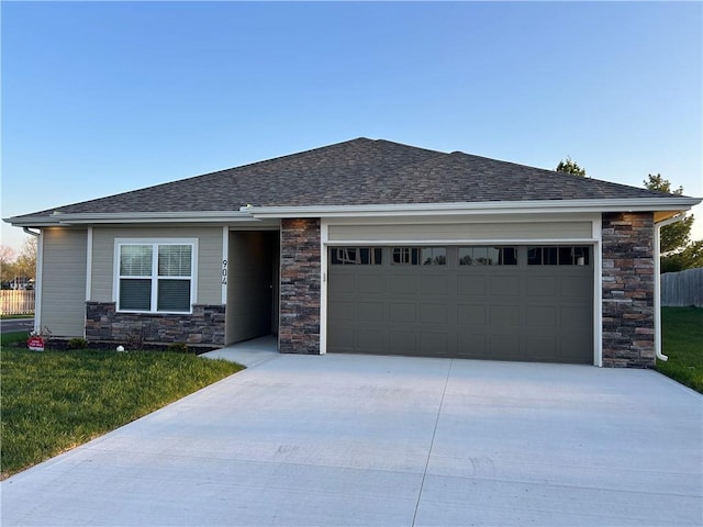 view of front facade with concrete driveway, a garage, stone siding, and a front lawn