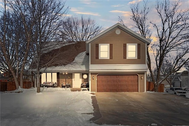 traditional-style house featuring a garage and concrete driveway