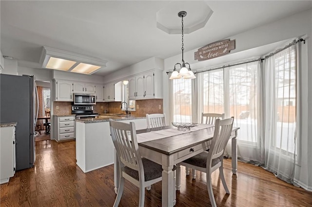 dining area with dark wood-style flooring