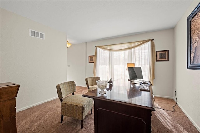 carpeted office with baseboards and visible vents