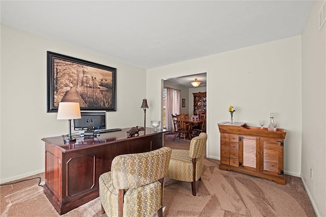 carpeted office space featuring visible vents and baseboards