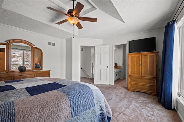 bedroom featuring light colored carpet, visible vents, ornamental molding, a ceiling fan, and a textured ceiling