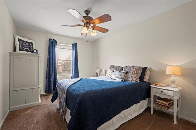 carpeted bedroom featuring ceiling fan and baseboards