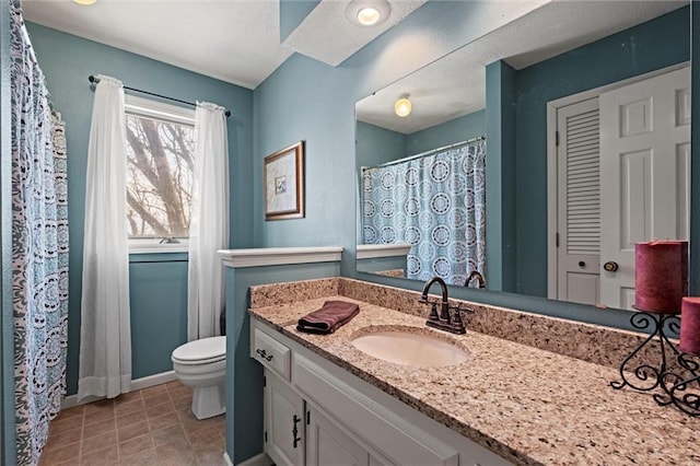 full bath featuring baseboards, vanity, toilet, and tile patterned floors