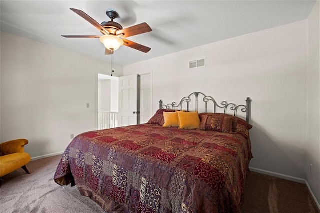 carpeted bedroom with baseboards, visible vents, and ceiling fan