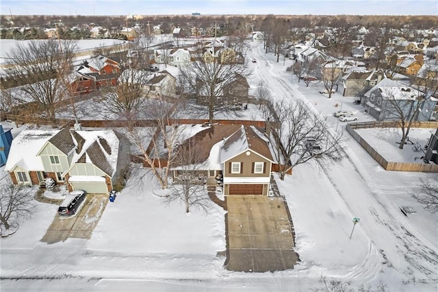 snowy aerial view with a residential view