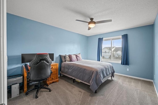 bedroom with a textured ceiling, carpet floors, ceiling fan, and baseboards