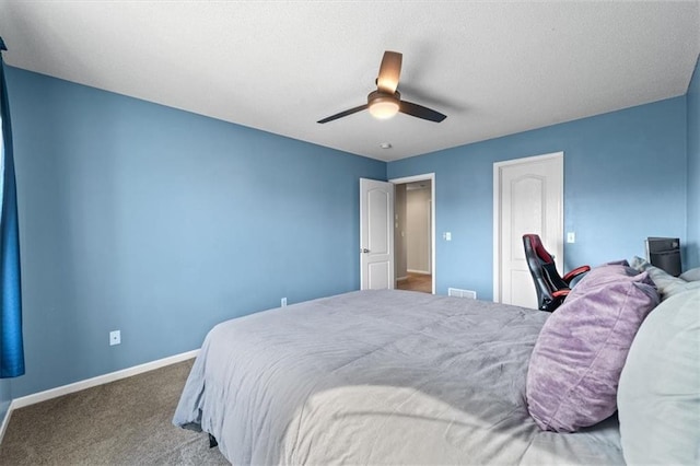 carpeted bedroom featuring ceiling fan and baseboards