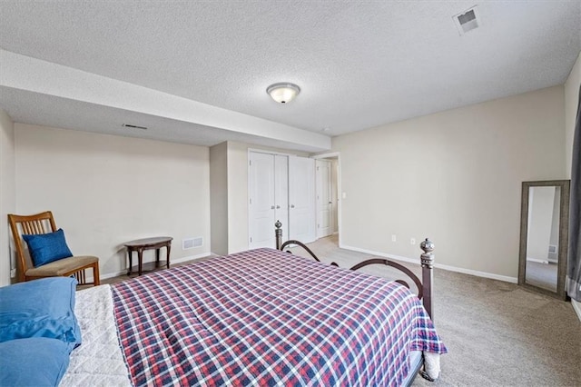 bedroom with light colored carpet, visible vents, a textured ceiling, and baseboards