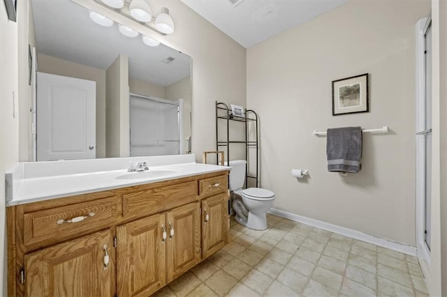 full bath featuring toilet, a stall shower, vanity, baseboards, and tile patterned floors